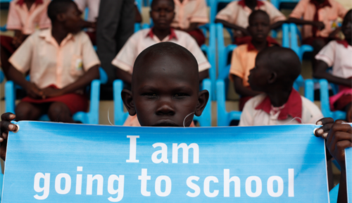 Pupil holds a banner for 'Back-to-school' campaign launched April 06th 2016